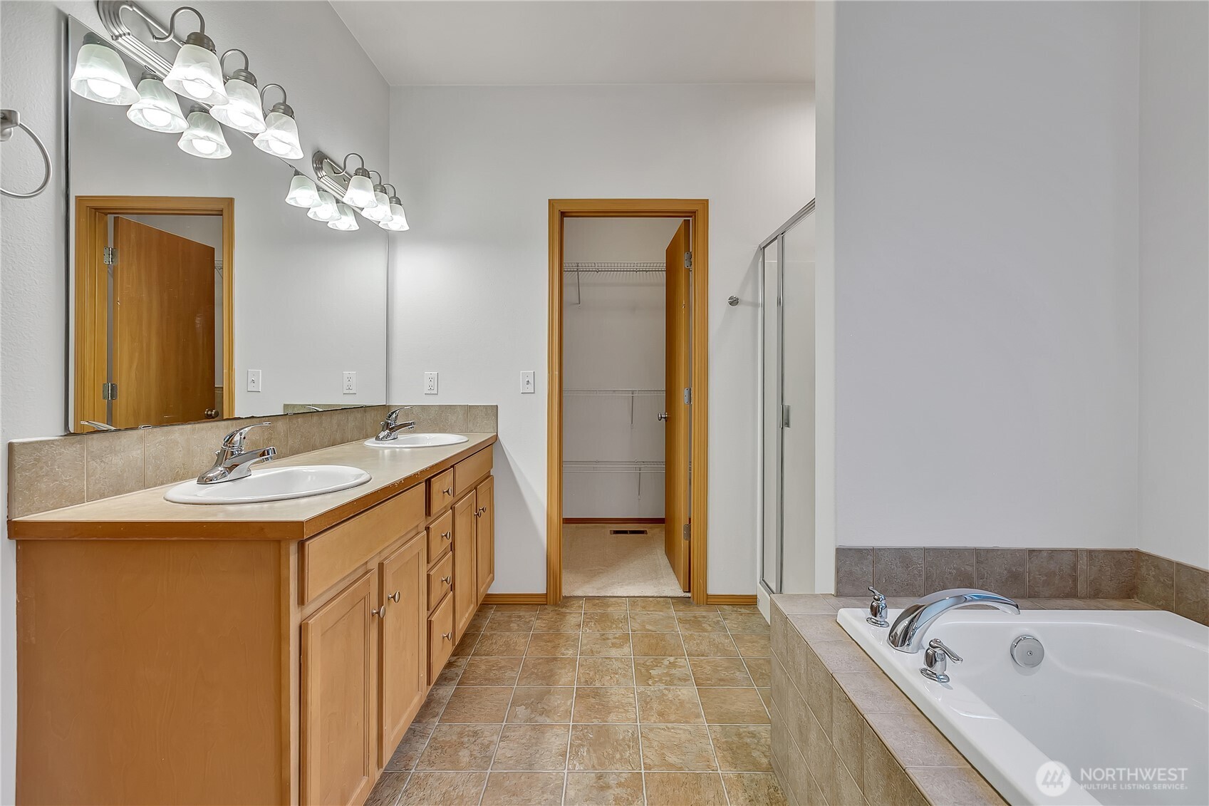 1720 Garfield Street, Unit 4 Enumclaw, WA 98022 - Photo 22 of 38 a bathroom with a granite countertop sink a large mirror and a bathtub
