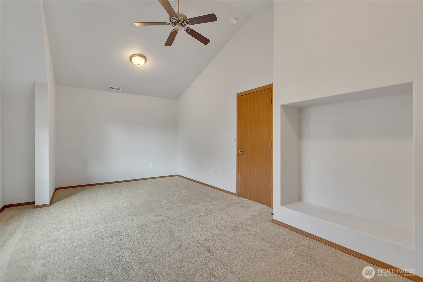 1720 Garfield Street, Unit 4 Enumclaw, WA 98022 - Photo 29 of 38 an empty room with a ceiling fan and carpet