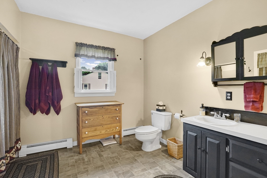 46 Charles Street Three Rivers, MA 01080 - Photo 24 of 42 a bathroom with a sink a toilet and vanity