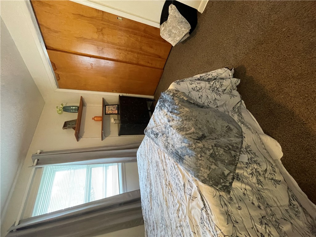 360 Ridge Street Piqua, OH 45356 - Photo 19 of 46 This cozy bedroom features warm wooden closet doors and soft carpeted flooring.