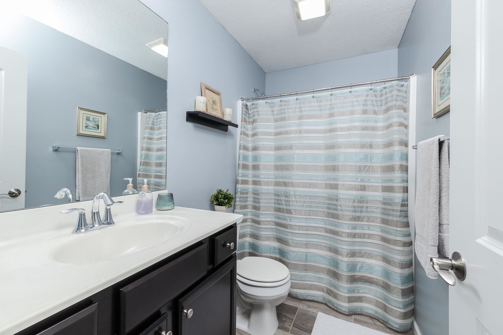 212 Springdale Avenue Bloomington, IL 61704 - Photo 21 of 37 a bathroom with a sink a toilet and shower curtain