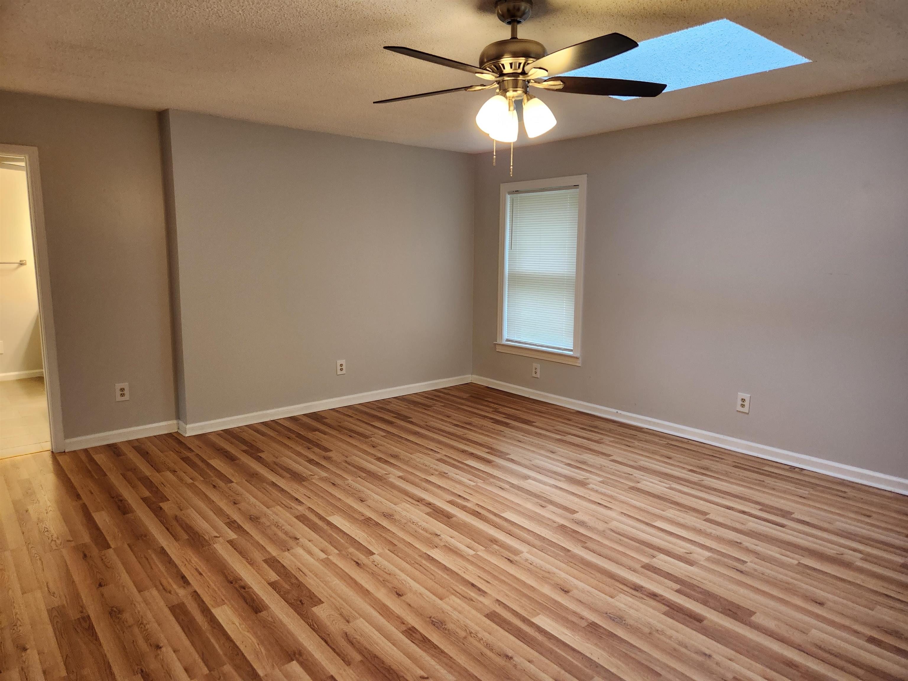 7188 Pleasant Ridge Road Arlington, TN 38002 - Photo 16 of 28 wooden floor in an empty room with a window