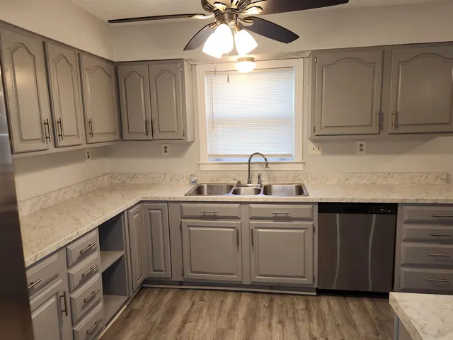 a kitchen with a sink cabinets and window