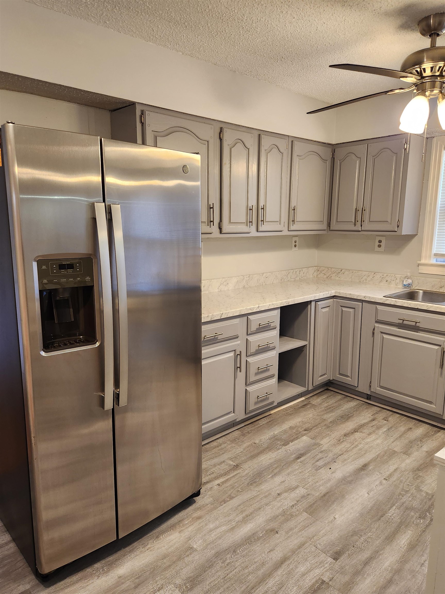 7188 Pleasant Ridge Road Arlington, TN 38002 - Photo 7 of 28 a kitchen with granite countertop a refrigerator and a sink