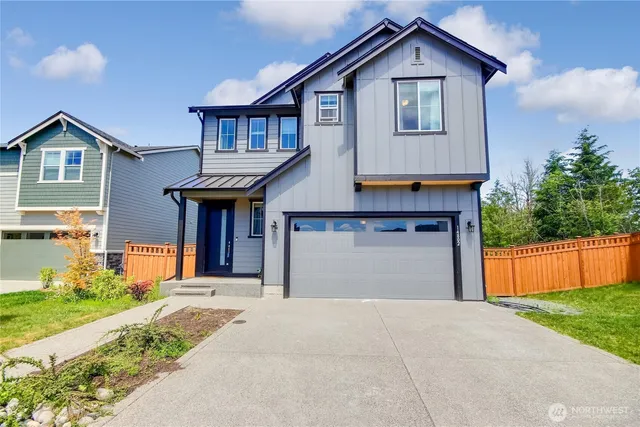 a front view of house with garage and yard