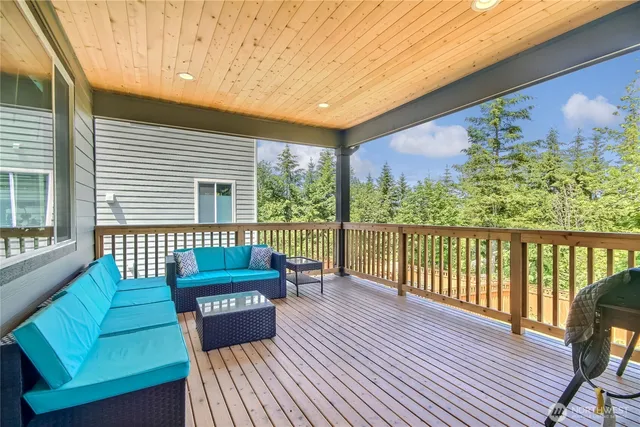 a balcony with furniture and wooden floor