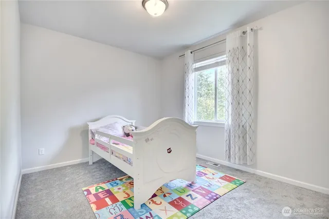 a bed room with a bed and a window