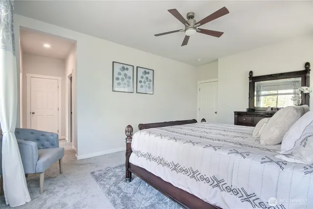 a bedroom with a bed lamp and a window