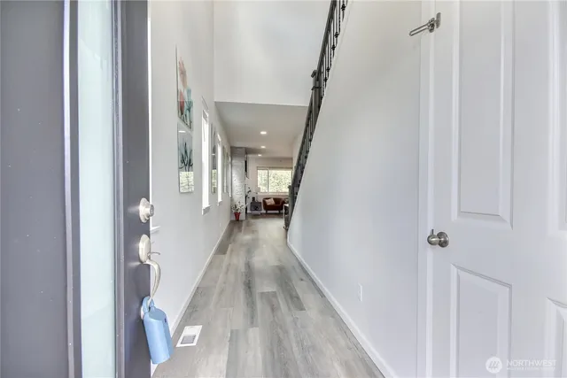 a view of hallway with wooden floor
