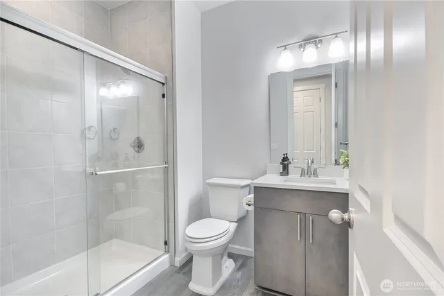 a bathroom with a toilet a sink and shower