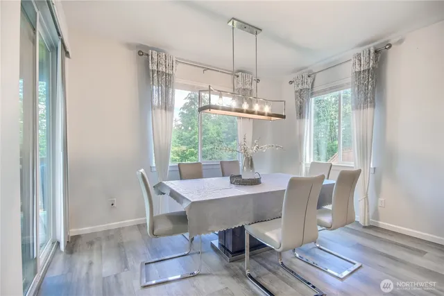 a view of a dining room with furniture window and wooden floor