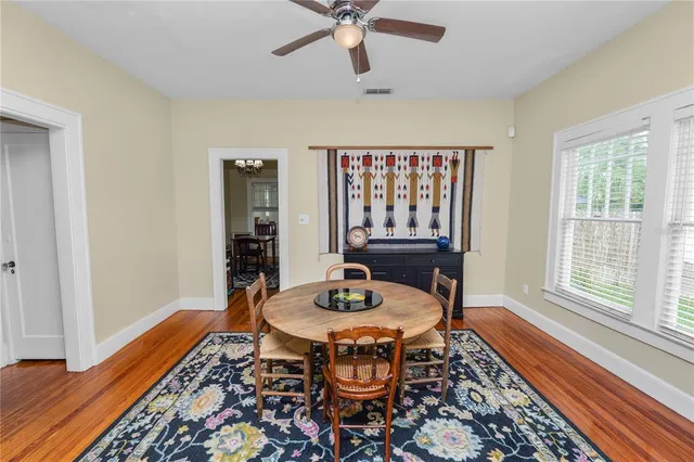 a dining room with furniture and wooden floor