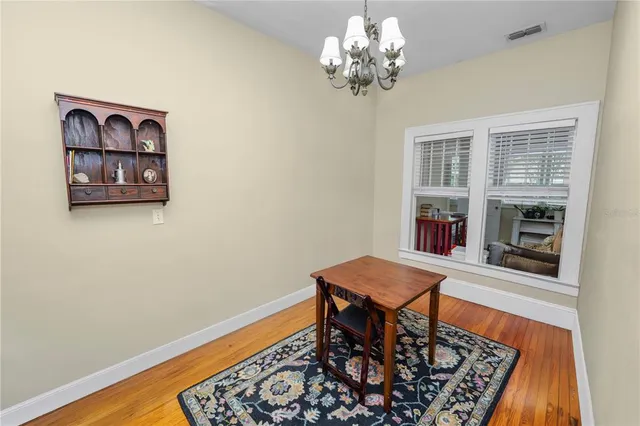 a view of a dining room with furniture wooden floor and a chandelier