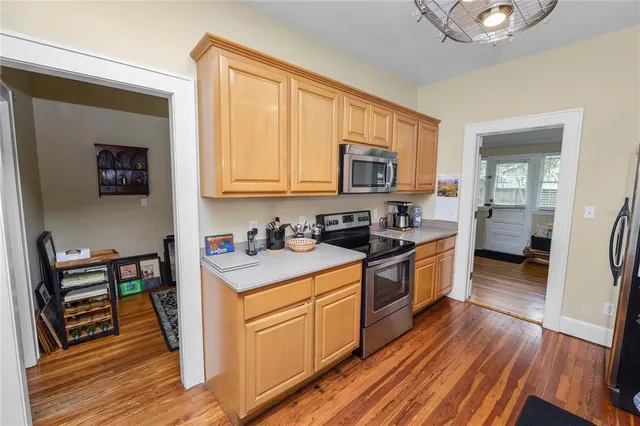 a kitchen with stainless steel appliances granite countertop a stove a sink and a microwave