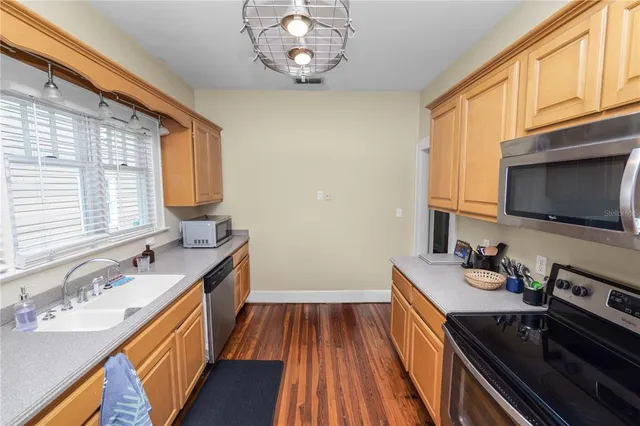 a kitchen with a sink stove and microwave