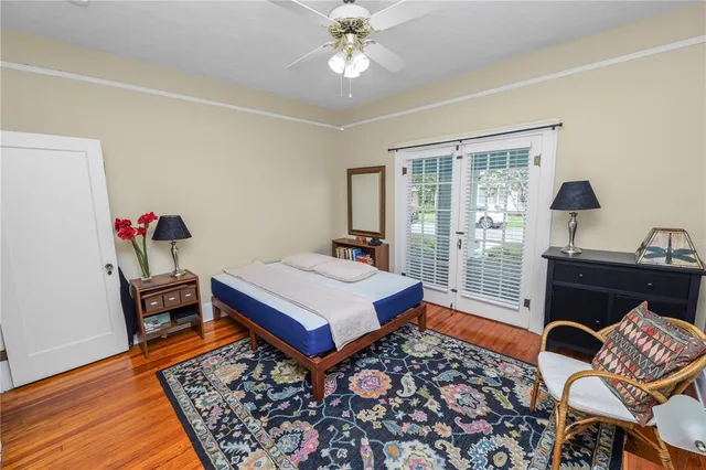a bedroom with a bed and wooden floor