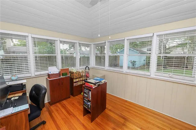 a living room with furniture and floor to ceiling windows