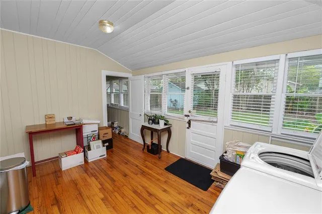 a bedroom with furniture and a wooden floor