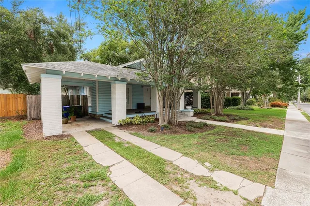 a view of a house with a yard patio and a garden