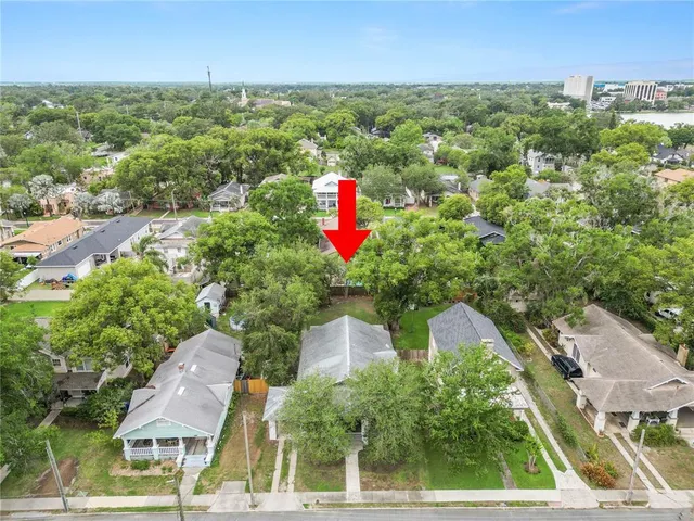 an aerial view of residential houses with outdoor space and street view