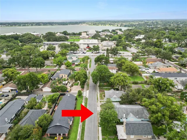 an aerial view of residential houses with outdoor space and street view