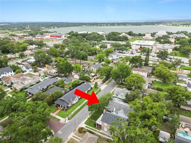 an aerial view of residential houses with outdoor space and swimming pool