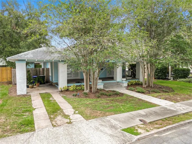 a view of a porch with chairs and potted plants