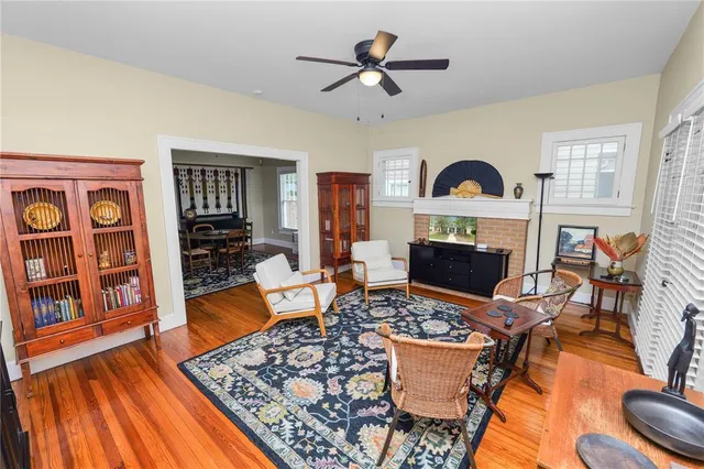 a living room with furniture a rug and a fireplace
