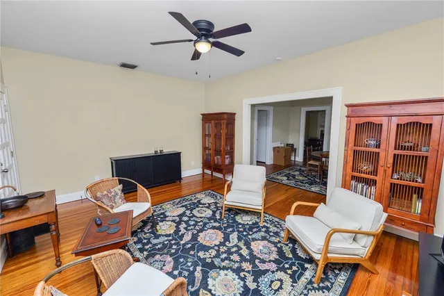 a living room with furniture a rug and a table