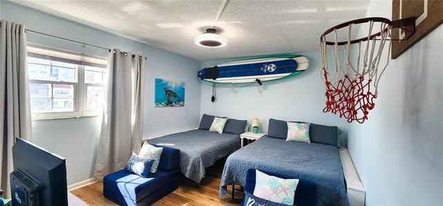 a bedroom with furniture and a flat screen tv