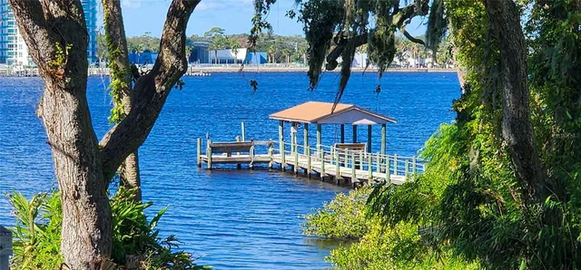 a backyard of a house with wooden floor table and chairs