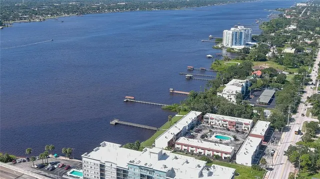 an aerial view of residential houses with outdoor space and street view