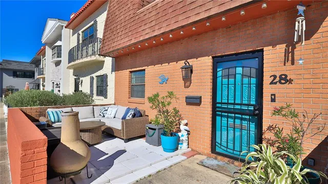 a front view of a house with garden and trees