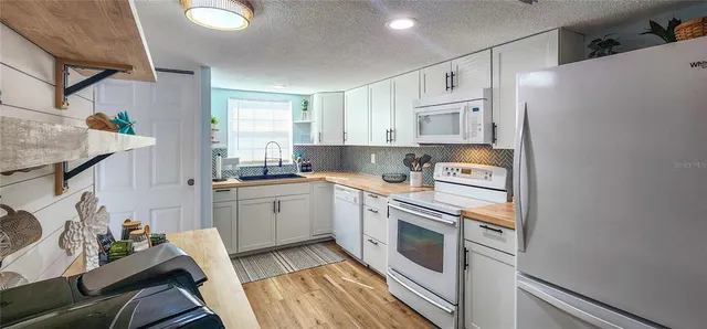 a kitchen with a sink and refrigerator