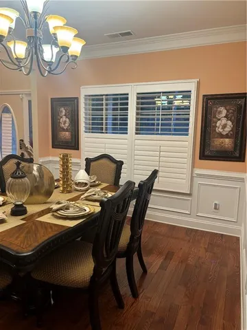 a view of a dining room with furniture and chandelier