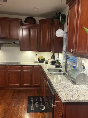 a kitchen with granite countertop a stove and a sink