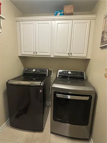 a living room with furniture and a large mirror
