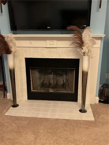 a bedroom with a bed and a television on dresser