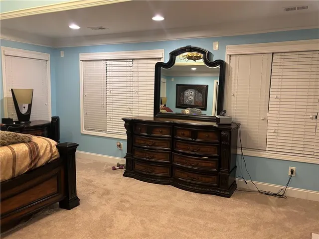 a bathroom with a granite countertop sink a mirror and shower