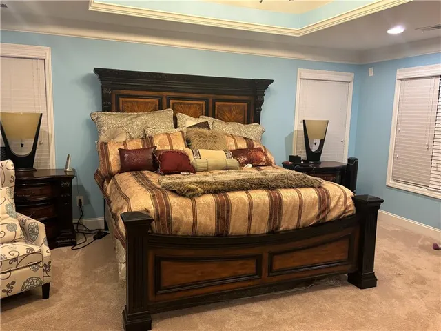 a bathroom with a granite countertop sink and a black white checkered floor