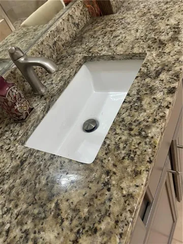a bathroom with a shower and a sink