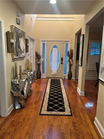 a room with lots of furniture and wooden floor