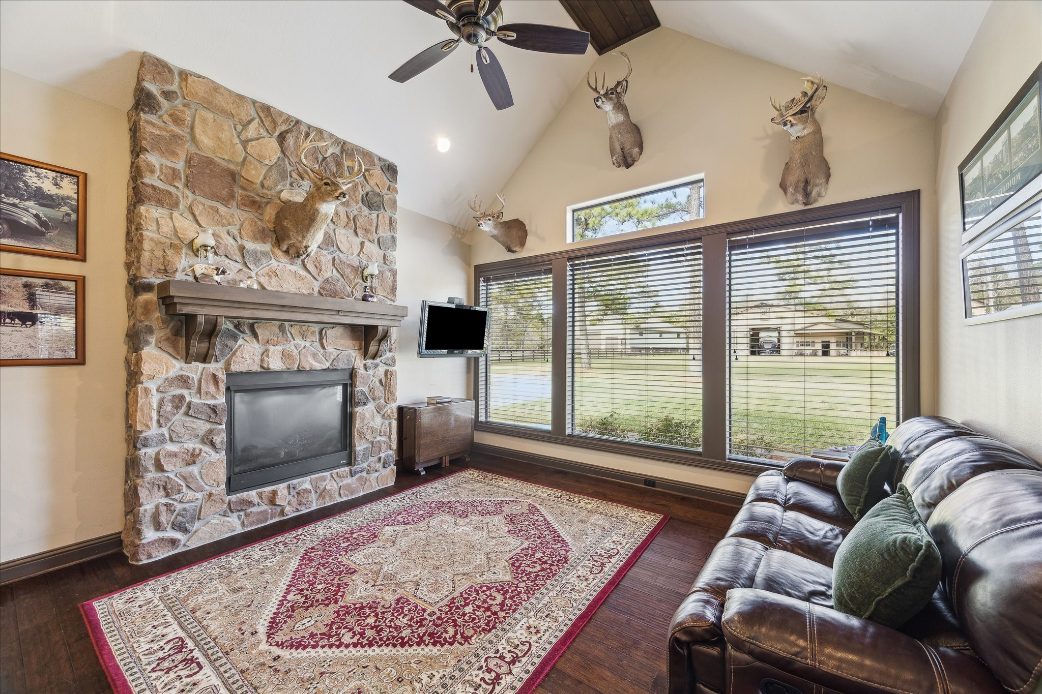 11 Willowcreek Ranch Road Tomball, TX 77377 - Photo 26 of 49 One of two dedicated office spaces, this one serves as a Man Cave! Boasting wood floors, a stone gas fireplace, vaulted ceiling accented by a cedar beam, there is no better place from which to work. The wall of windows provides entrancing views. A commercial grade steam shower and proper sauna are connected directly to this office. A French door enables access to the covered patio and pool. A man cave at its finest.