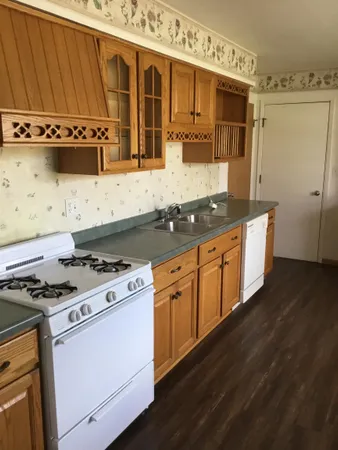 a kitchen with stainless steel appliances a stove a sink and a microwave