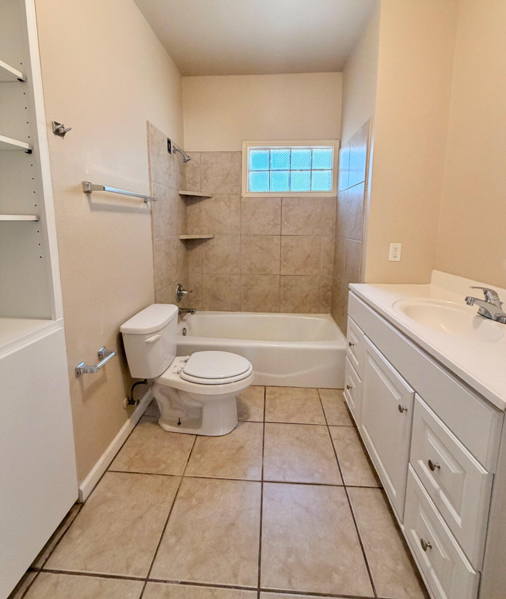 2301 49th Street Lubbock, TX 79412 - Photo 12 of 18 a bathroom with a sink a toilet and shower