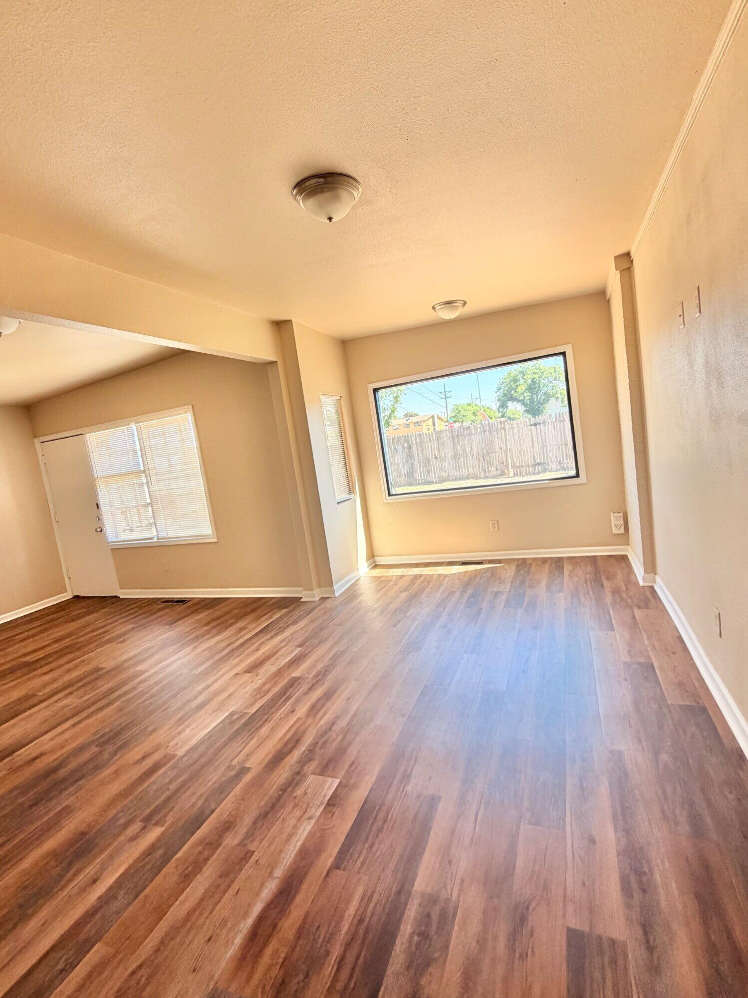 2301 49th Street Lubbock, TX 79412 - Photo 4 of 18 an empty room with wooden floor and windows