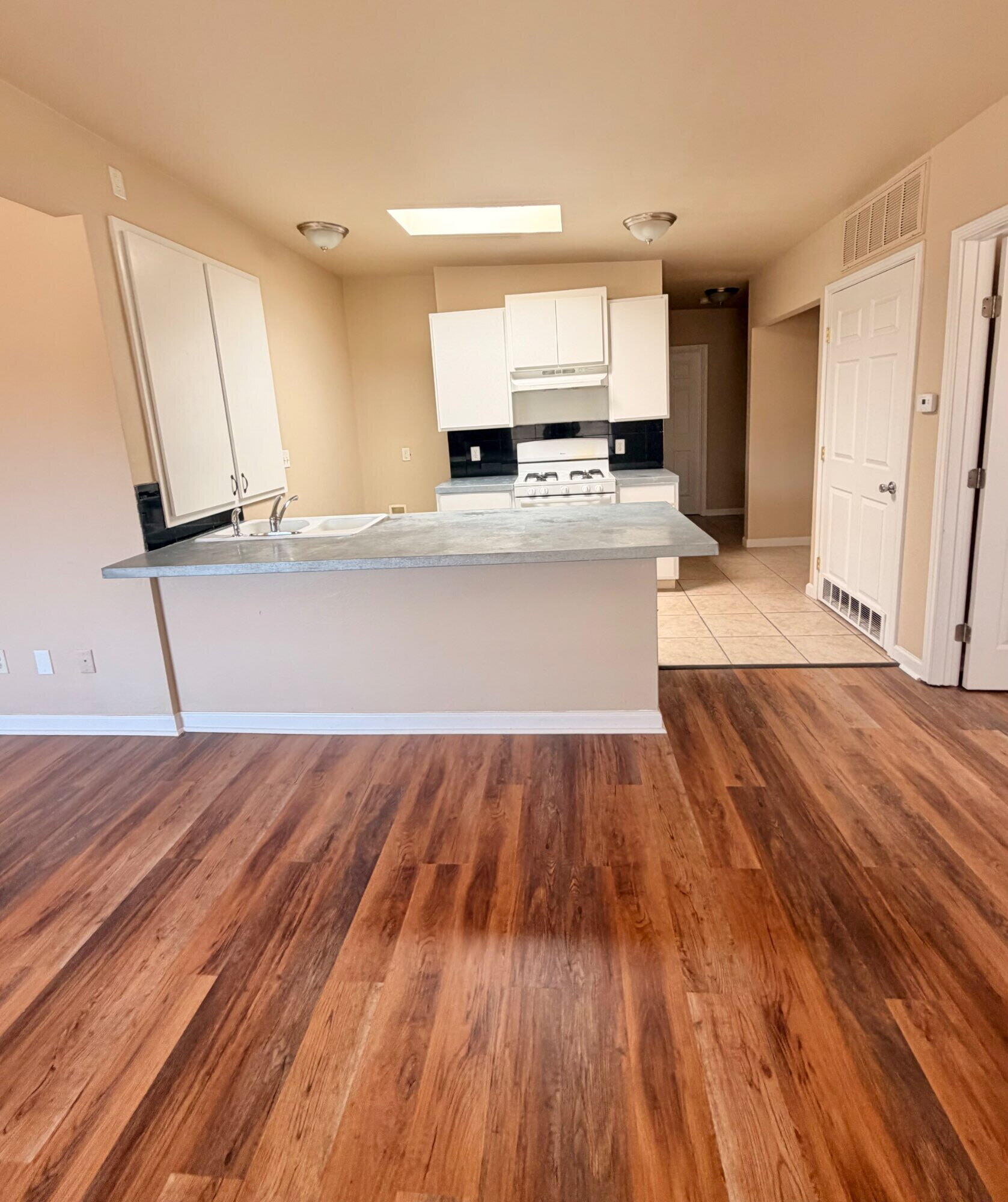 2301 49th Street Lubbock, TX 79412 - Photo 5 of 18 a view of kitchen with wooden floor and electronic appliances