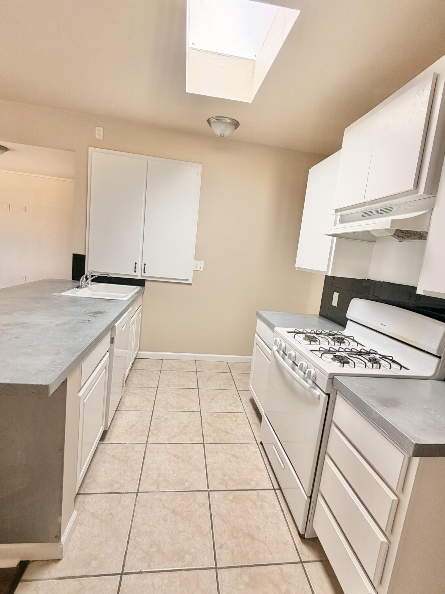 2301 49th Street Lubbock, TX 79412 - Photo 7 of 18 a kitchen that has a stove and a sink