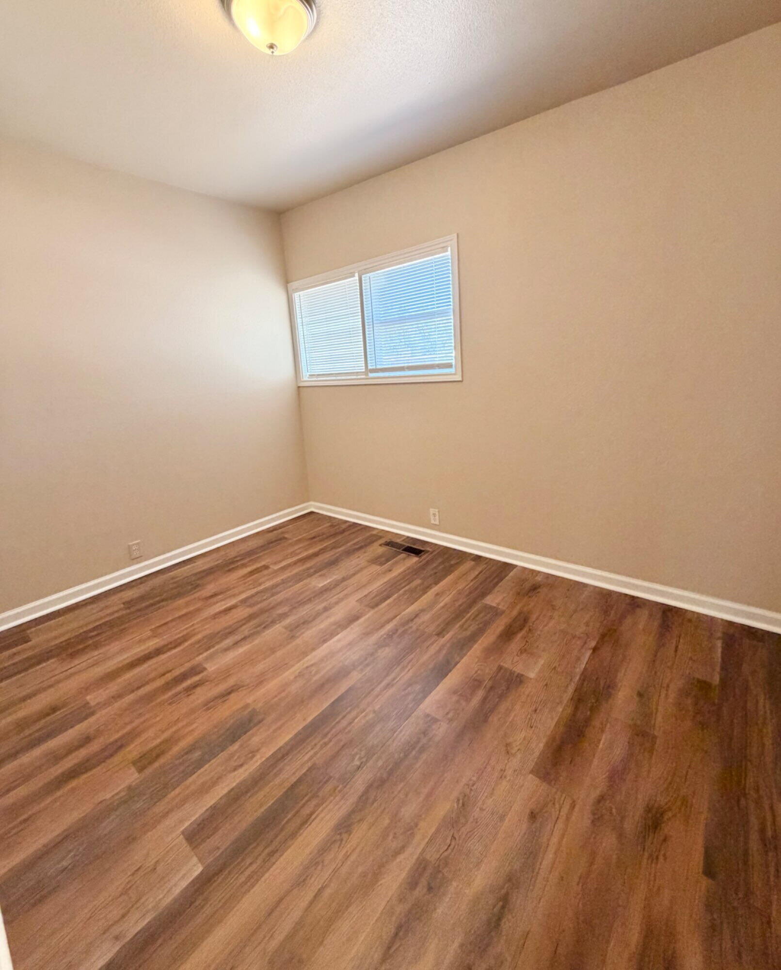 2301 49th Street Lubbock, TX 79412 - Photo 8 of 18 a view of room with wooden floor and fan