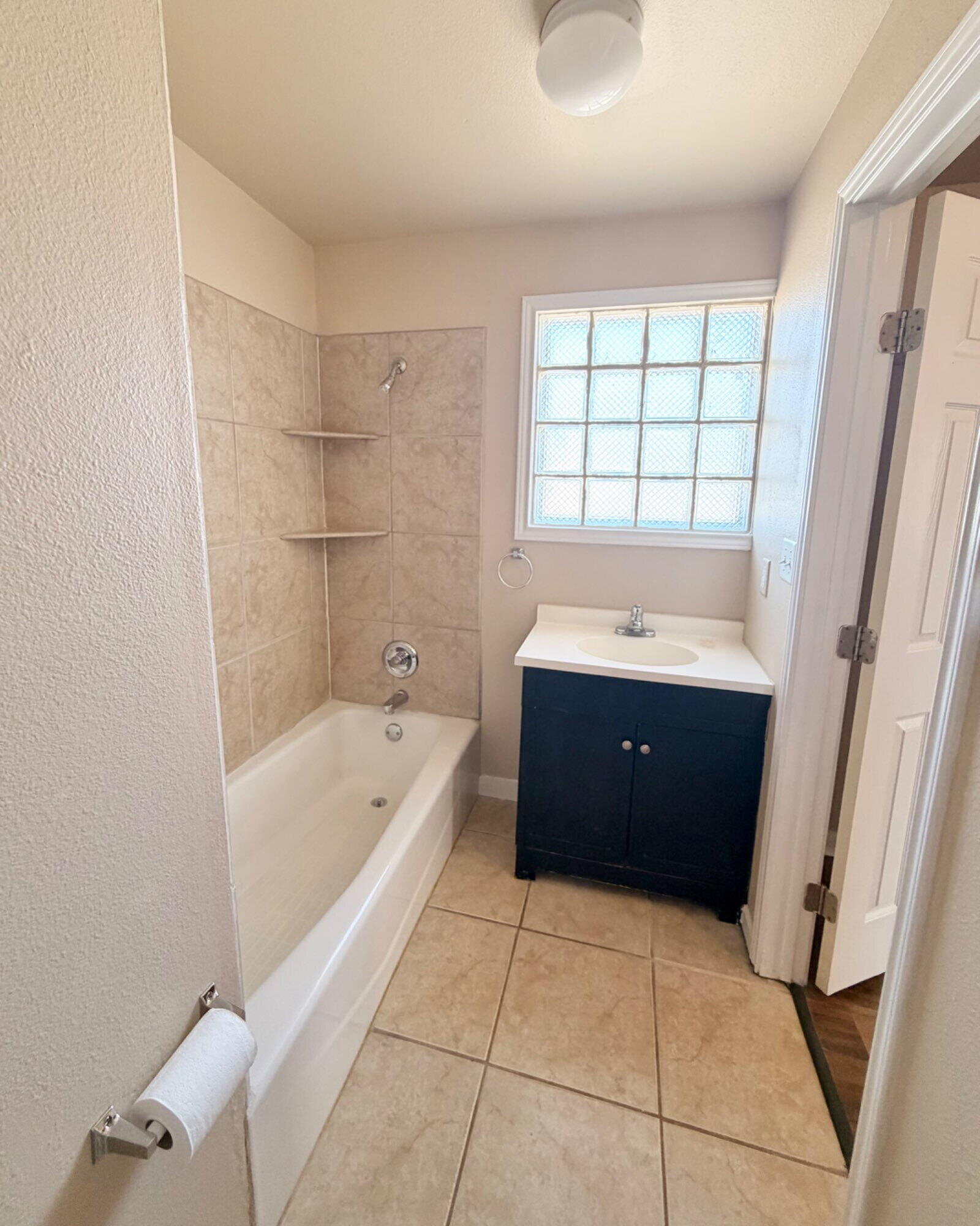 2301 49th Street Lubbock, TX 79412 - Photo 9 of 18 a spacious bathroom with a tub sink shower and a mirror